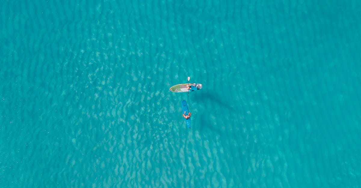 Measurement of water - Person in White Shirt Riding on White Boat on Blue Water