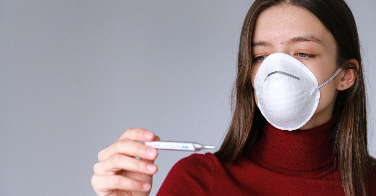 Meat thermometer doesn't "stop" measuring. How to know actual measurement? - Woman in Face Mask Checking Thermometer