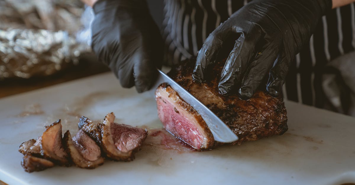Medium-rare sous vide steak - achieving coloring without slicing? - Close-Up Shot of a Person Slicing Cooked Meat