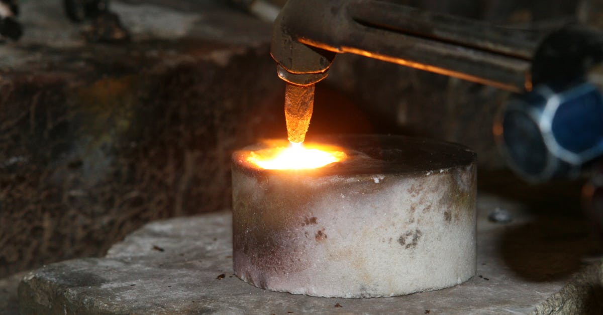 Melting sugar on creme brulee with blow torch - Selective Focus Photography of Welding Torch on Concrete Round Bar
