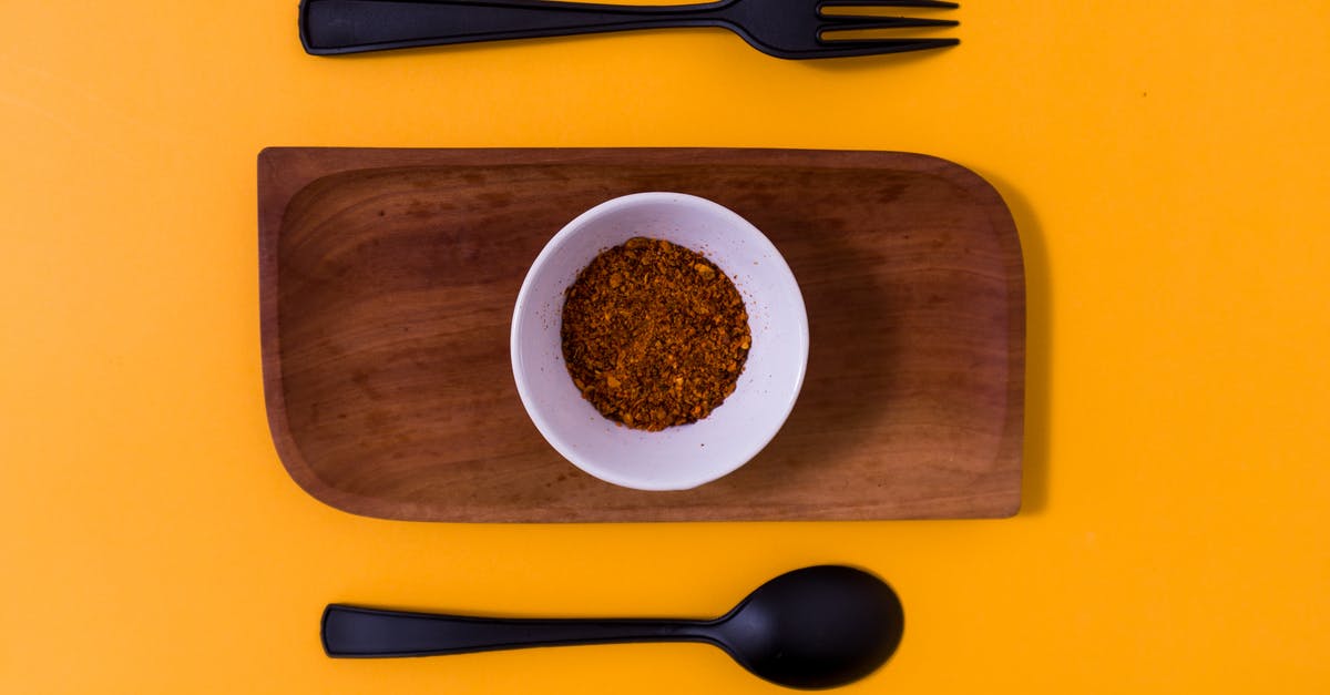 Methods for seasoning wooden spoons? - Spicy Seasoning in White Bowl on Brown Wooden Platter Beside Spoon and Fork