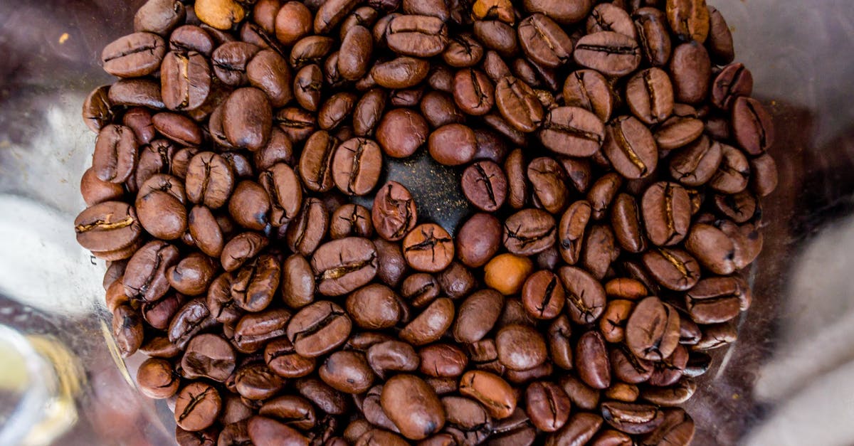 microplastics from plastic pepper grinders? - From above of plastic coffee grinder full of fresh aromatic coffee beans in cafe