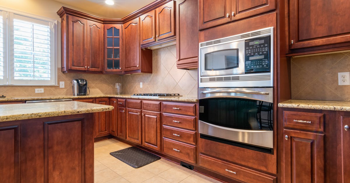 Microwave Oven Operating Frequencies - Black and Silver Microwave Oven on Brown Wooden Kitchen Cabinet