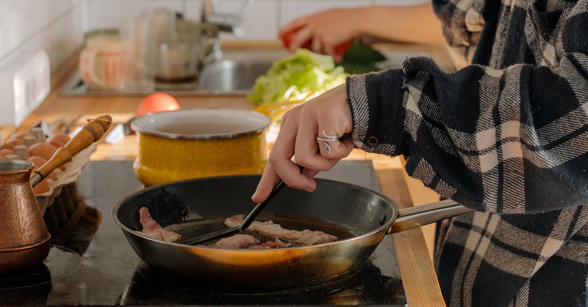 Milk pan for induction hob - Person Holding Black Ceramic Bowl With Soup