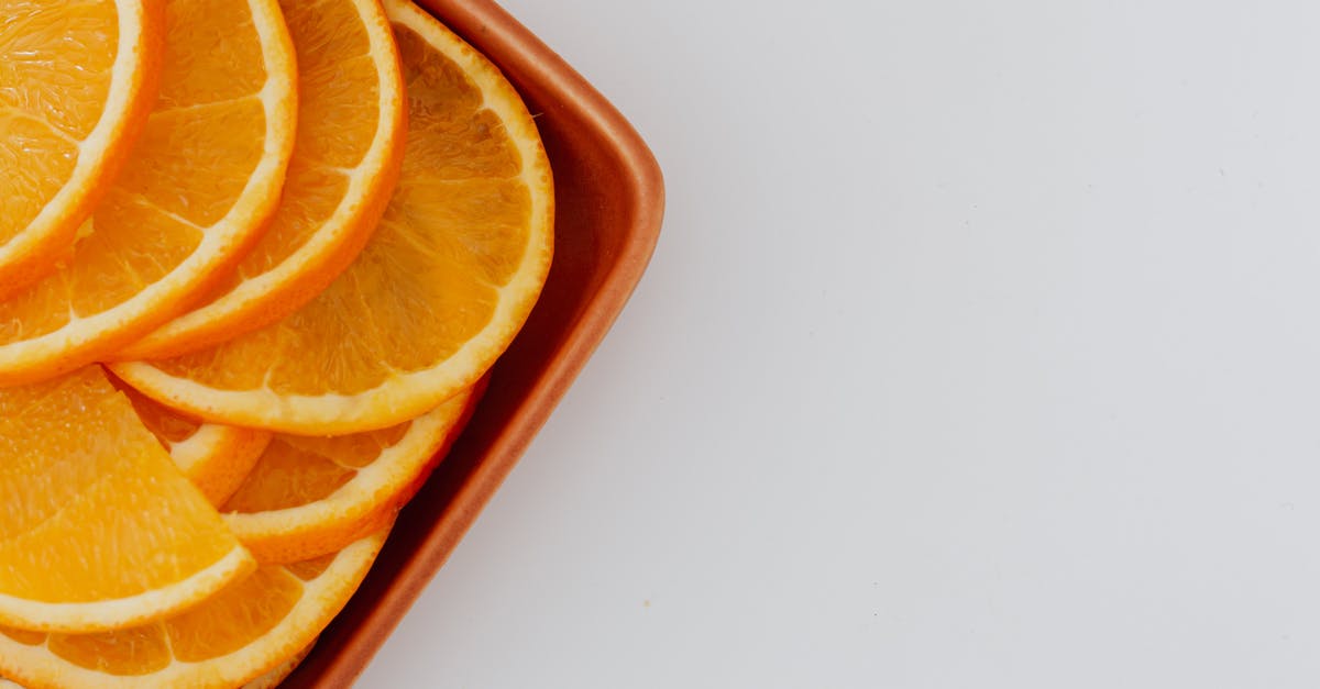 Minimal tasty preparation of raw chayote - Minimalistic layout of fresh orange slices on ceramic rectangular plate