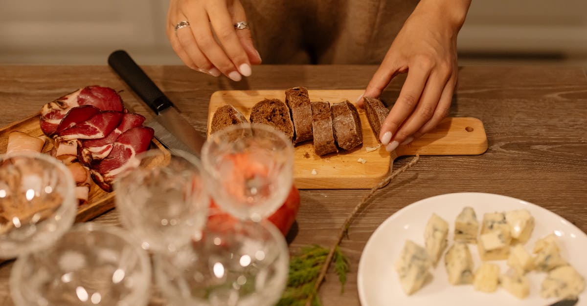 Minimum preparation for baking a whole fish - Person Holding Clear Wine Glass