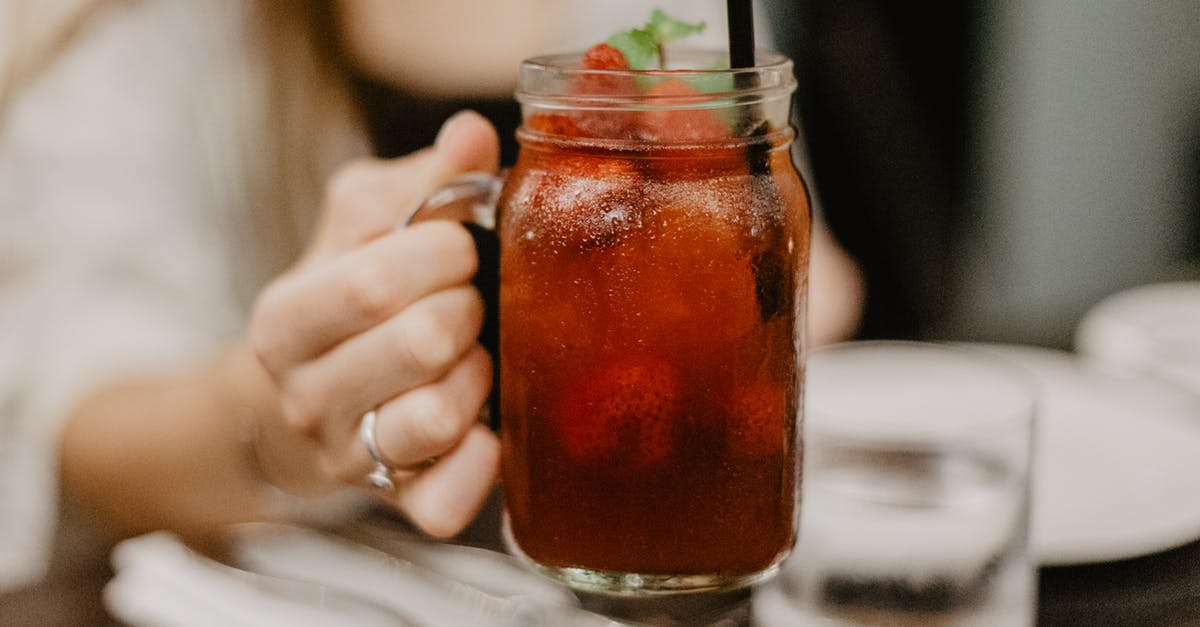 Mint vs Peppermint - Crop female drinking cold beverage in bar