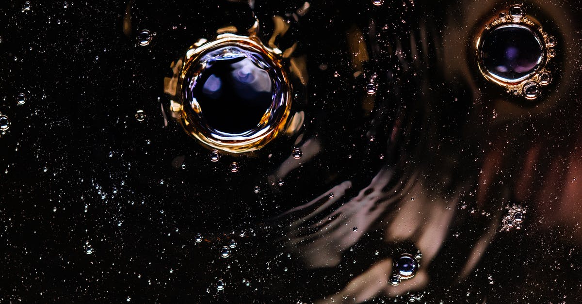 mixed egg and bicarbonate of soda - Bubbles and ripples on dark drink surface