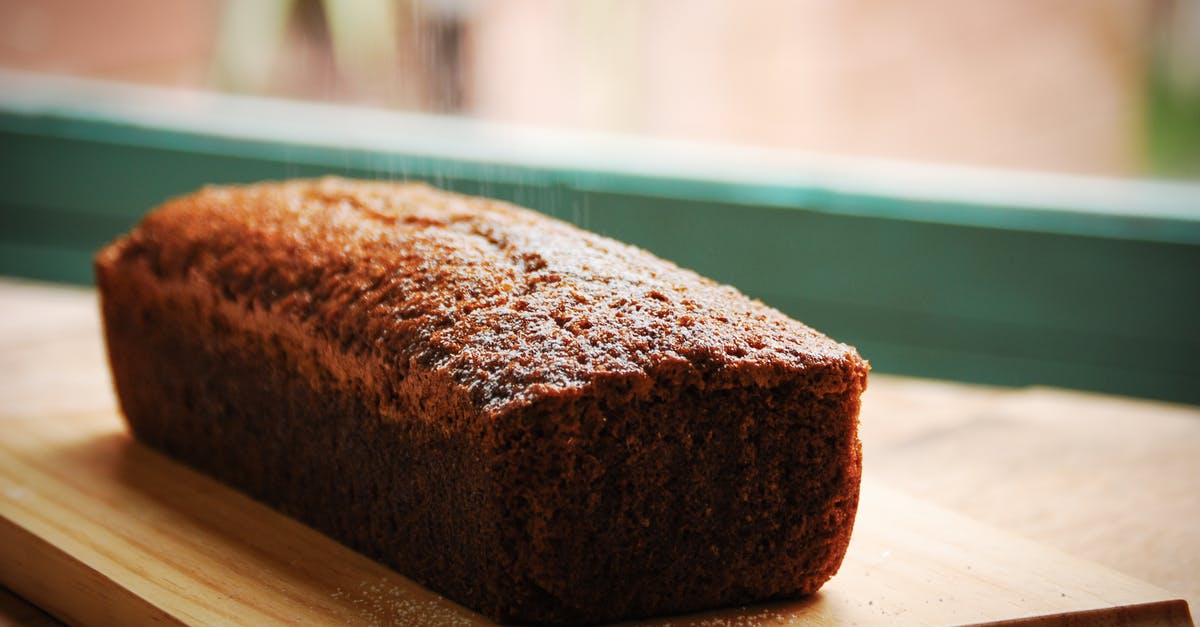 Mixed-Up cake recipe instructions - Closeup of sweet delicious fresh baked banana bread cake placed on wooden cutting board in kitchen