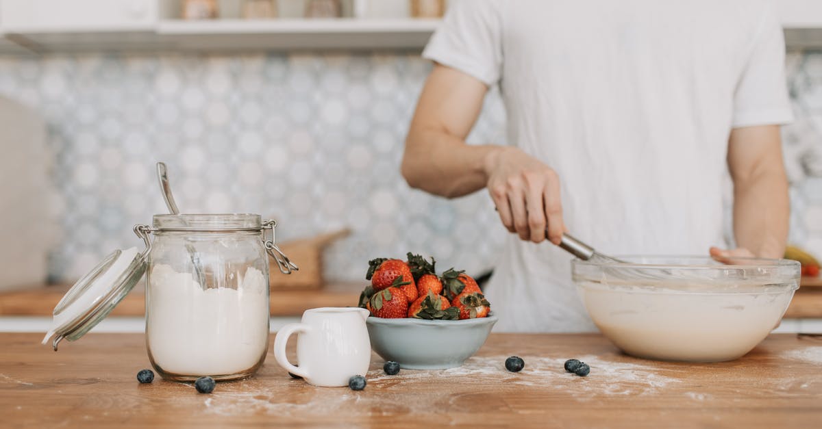 mixing cake batter in a blender? - A Man Whisking a Pancake Batter