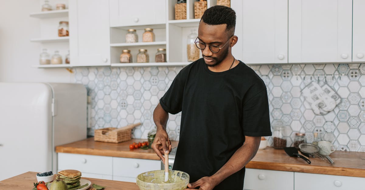 Mixing cheesecake batter with an immersion blender - A Man Mixing Batter in a Bowl