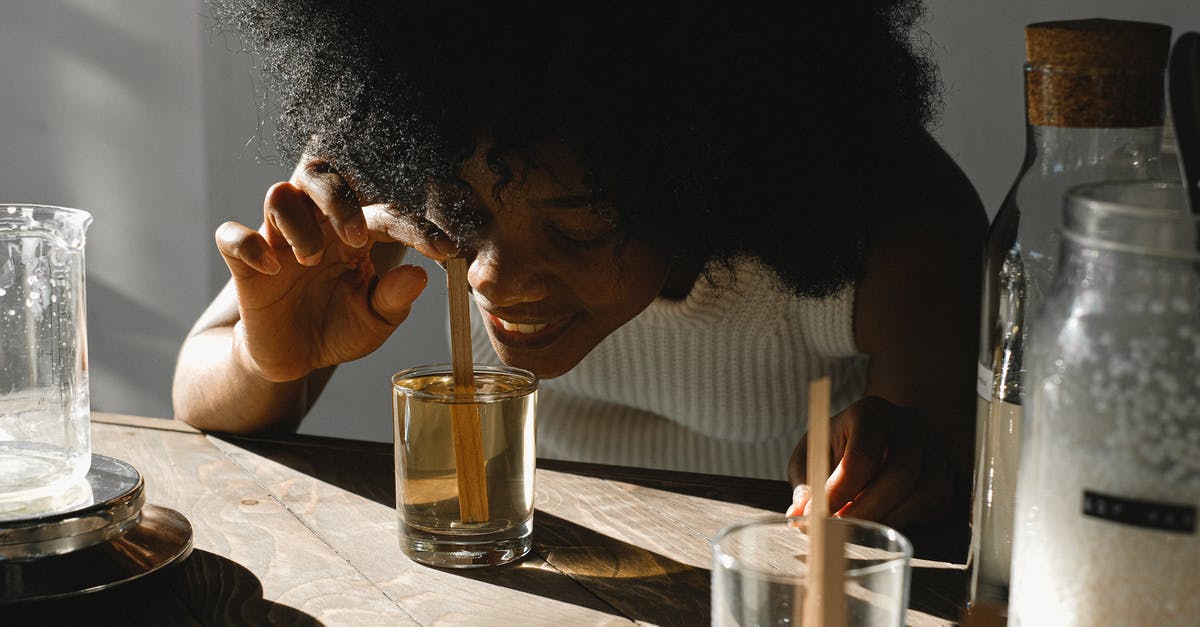 Mixing liquid margarine and water - Woman Smelling A Liquid Mixture