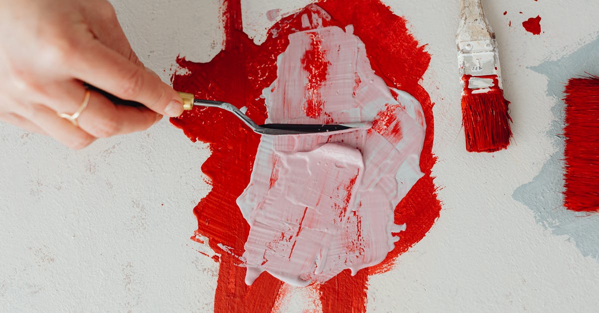 Mixing mozzarella without clumping - Person Holding Red Paint on White Wall