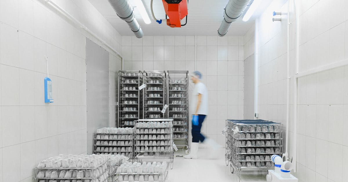 Mold in storage - Man in Blue T-shirt and Blue Denim Jeans Standing on White Floor Tiles