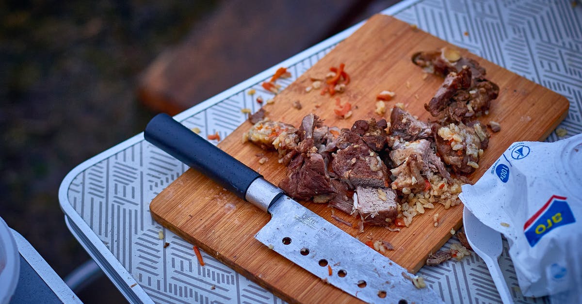 Mongolian BBQ Meat Cuts? - Sliced Cooked Meat on Brown Wooden Chopping Board with a Knife on Picnic Table