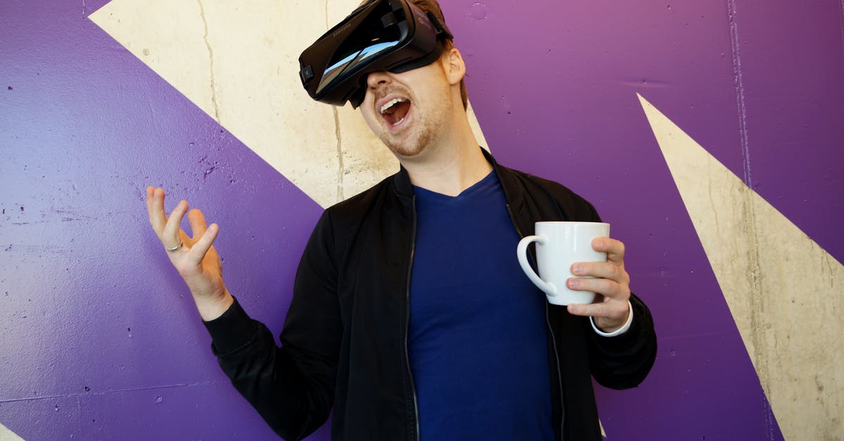 Mr. Coffee seems to know the future - Man Wearing Black Virtual Reality Headset while Holding White Mug