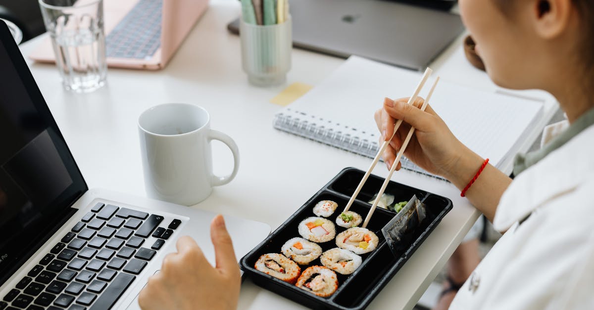 Mushy sushi surimi texture? - Person Holding Chopsticks on White Ceramic Plate