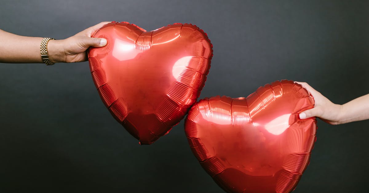 My éclair (pâte à choux) was doughy - Two Persons Holding Two Red Heart Shaped Balloons