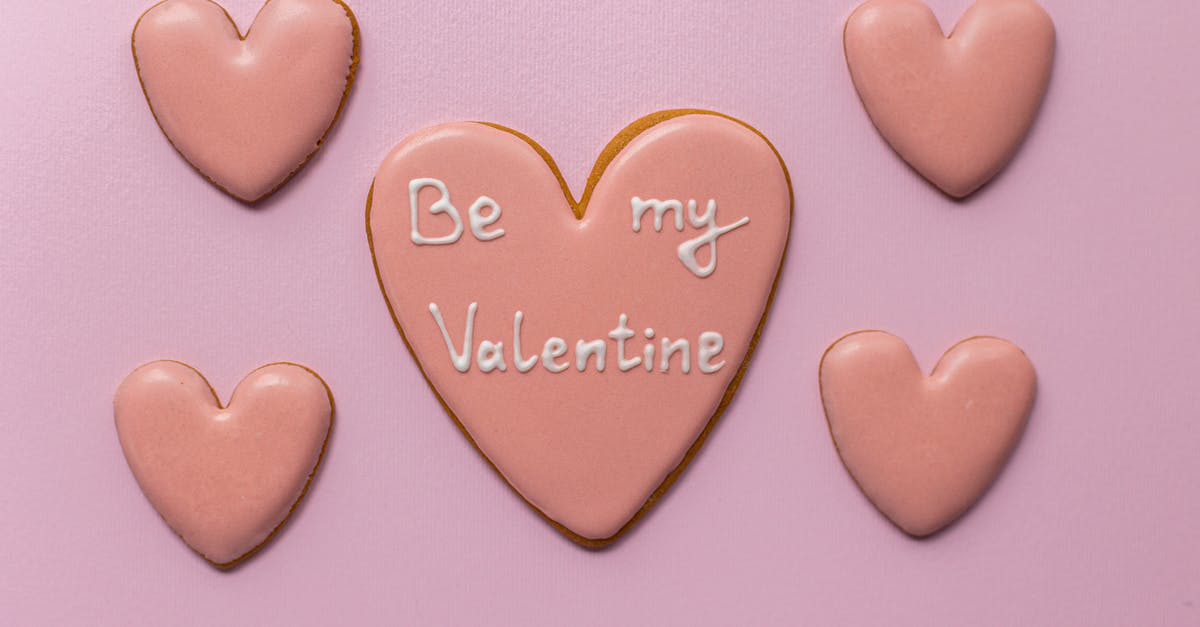 My brisket is too sweet - Top view of sweet heart shaped cookies saying Be My Valentine on pink background