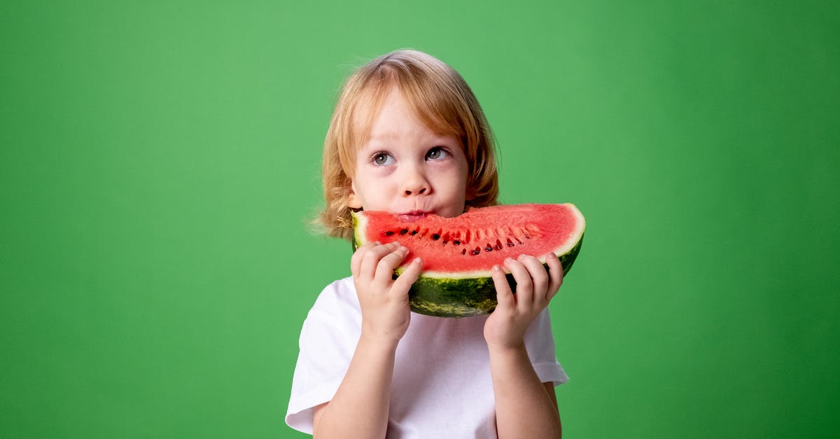 My curry is going funny I don't know why - Girl in White Long Sleeve Shirt Eating Watermelon