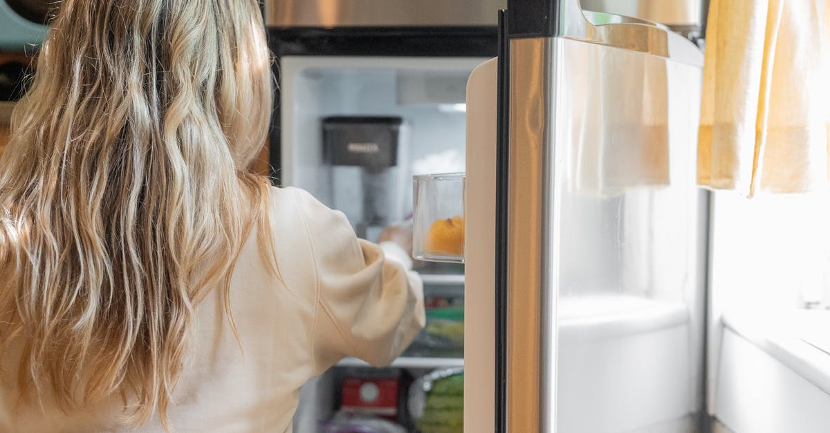 My jello is not getting firm in the refrigerator - Woman Getting Some Foods in the Refrigerator