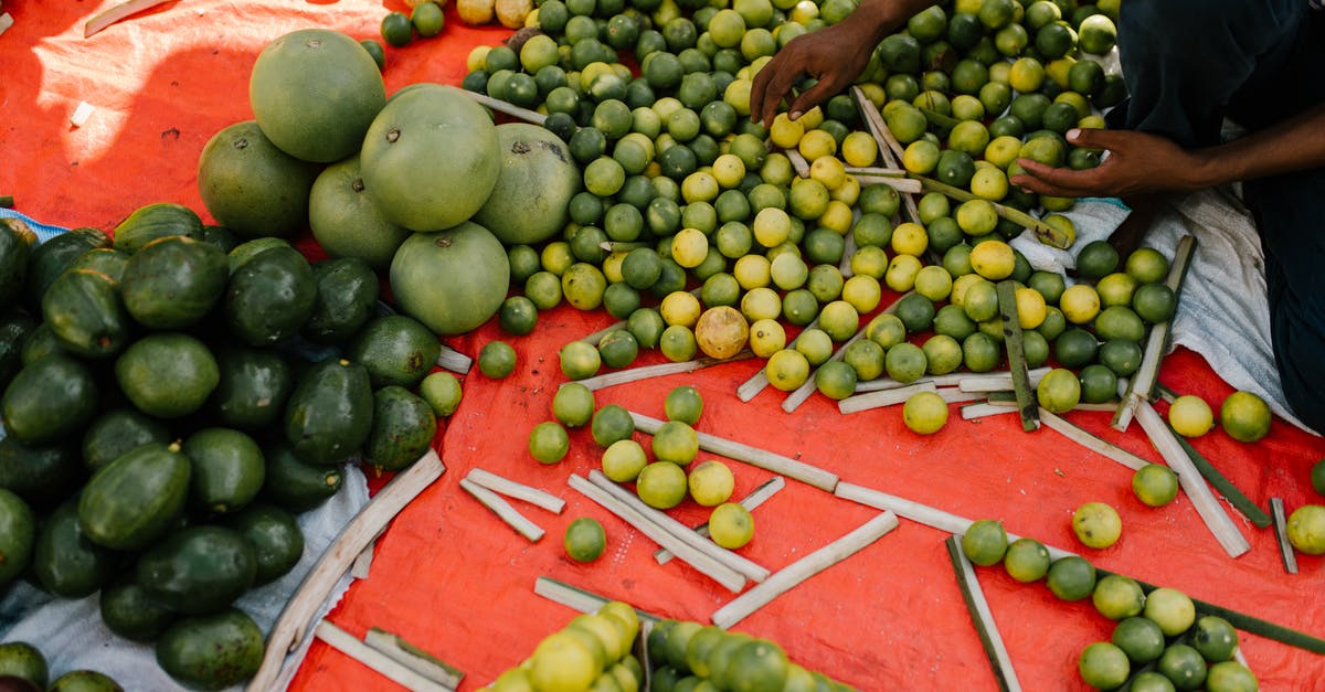 My mango and lime achar is fermenting in the mustard oil - Crop ethnic person with harvest of exotic fruits