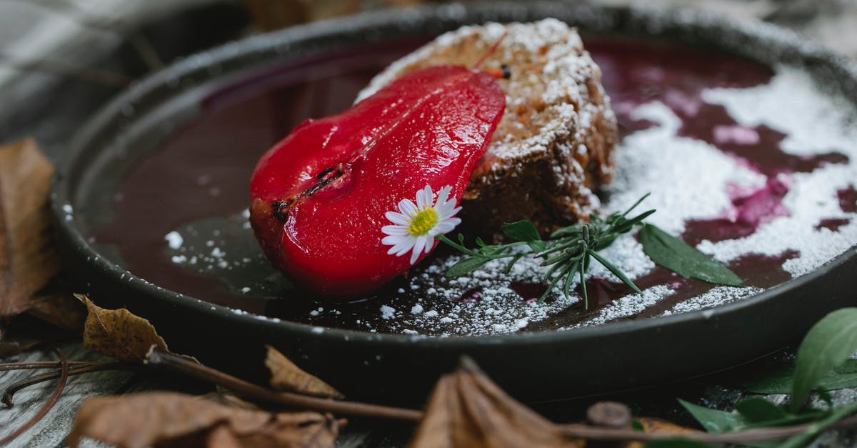 My soup tastes tart... Is it safe to eat? - Appetizing composition of yummy sweet pie slice garnished with red pear and chamomile while served on black plate