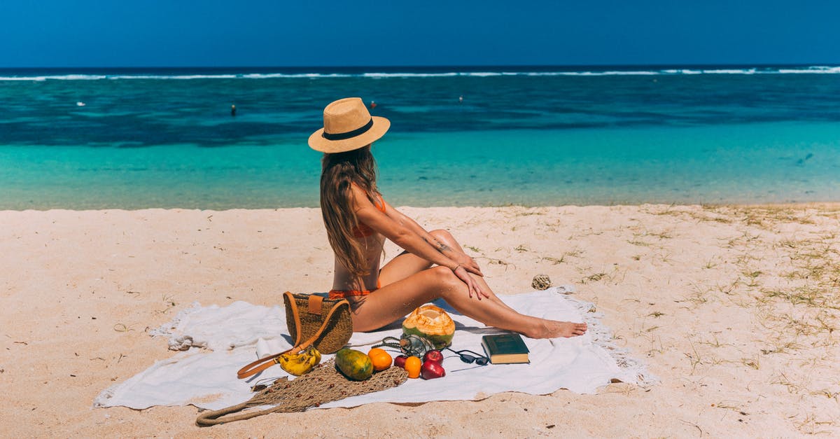 Mysterious bitter taste from tropical fruits and coconut - A Woman Sitting on a Beach Towel