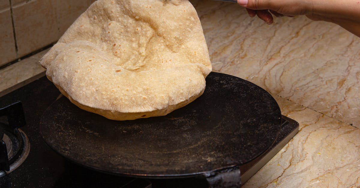 Naan without tandoor? - Person Holding Stainless Steel Bread Knife