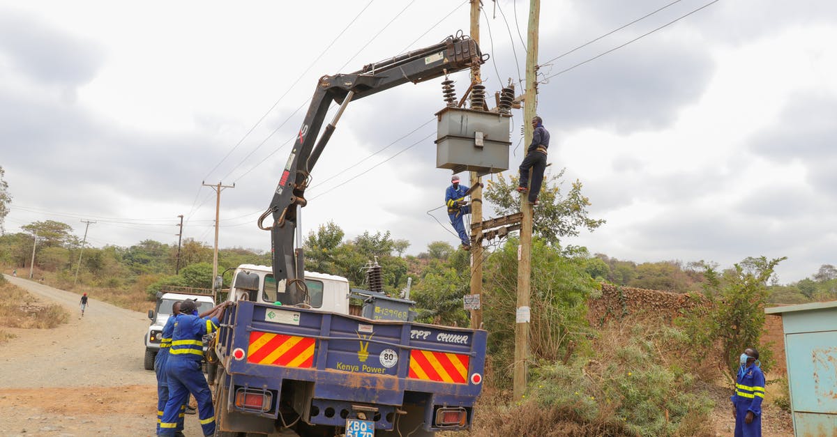 Need to maintain gelato at 10-18 °F without electricity - Men Working and Fixing an Electricity Pole 