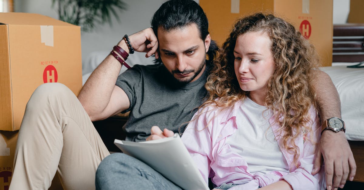 New corned beef ideas [closed] - Pensive male and female in casual clothes sitting together among boxes and writing notes in notebook while leaning on bed