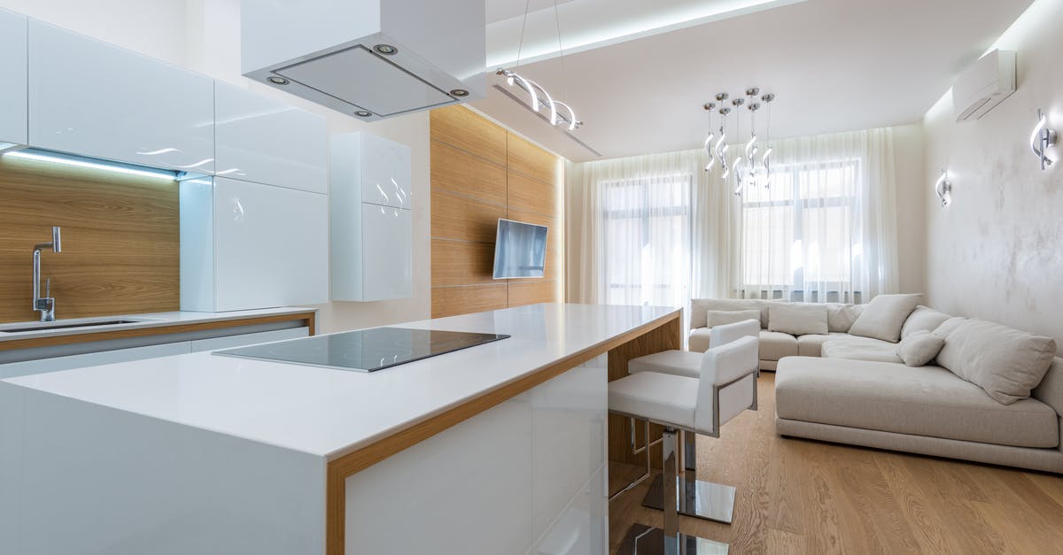 New crockpot cook times rule? - White kitchen counter with stove placed in kitchen zone against living room in contemporary apartment