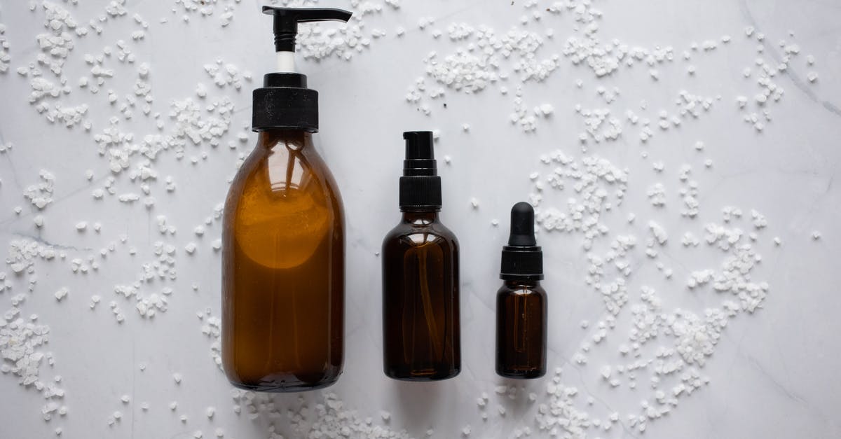 New oil vs old oil - Bottles of cosmetic products placed on white surface