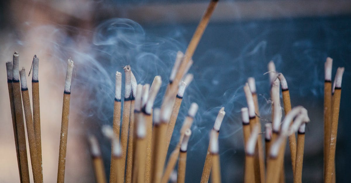 No lower heating element - Various types of smoldering aroma sticks with smoke on stand in cozy apartment