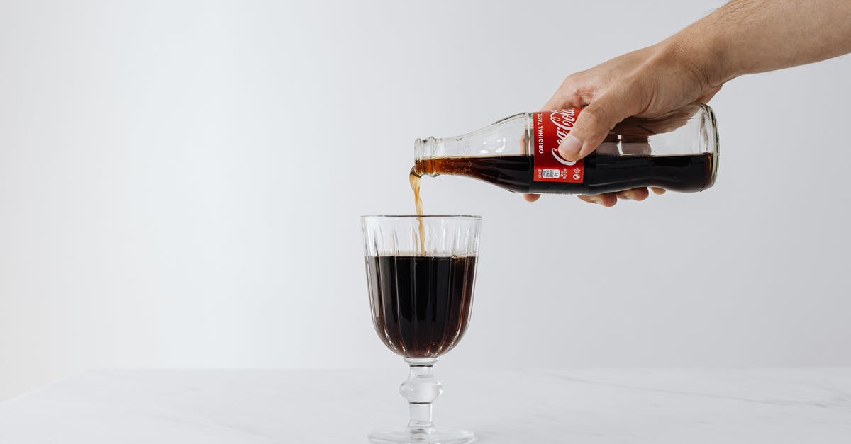 Nonalcoholic Substitute for Marsala Wine - Crop man pouring soda into wineglass on table