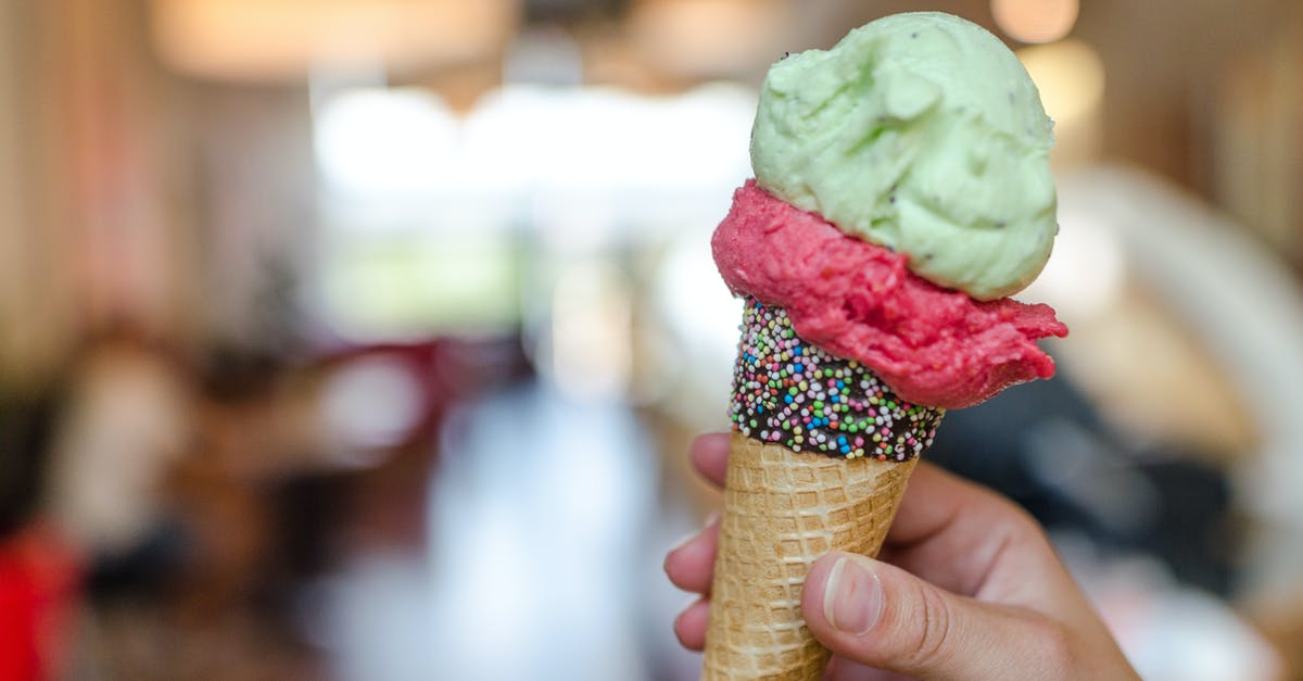 Non-dairy ice cream - Close-up Photo of Person Holding Assorted-flavor Ice Cream on Cone