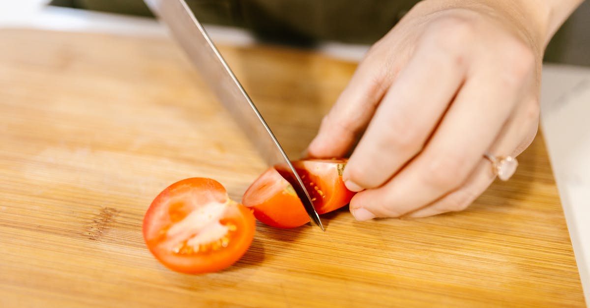 Non-plastic cutting board that can be cleaned in a dishwasher - Unrecognizable Female Hands Cutting Tomato into Pieces with Kitchen Knife