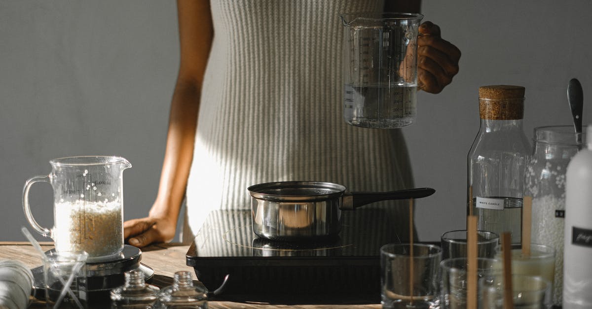 Not sure of slow cooker setting in my multi pot - Crop black woman with melted wax at stove making candles