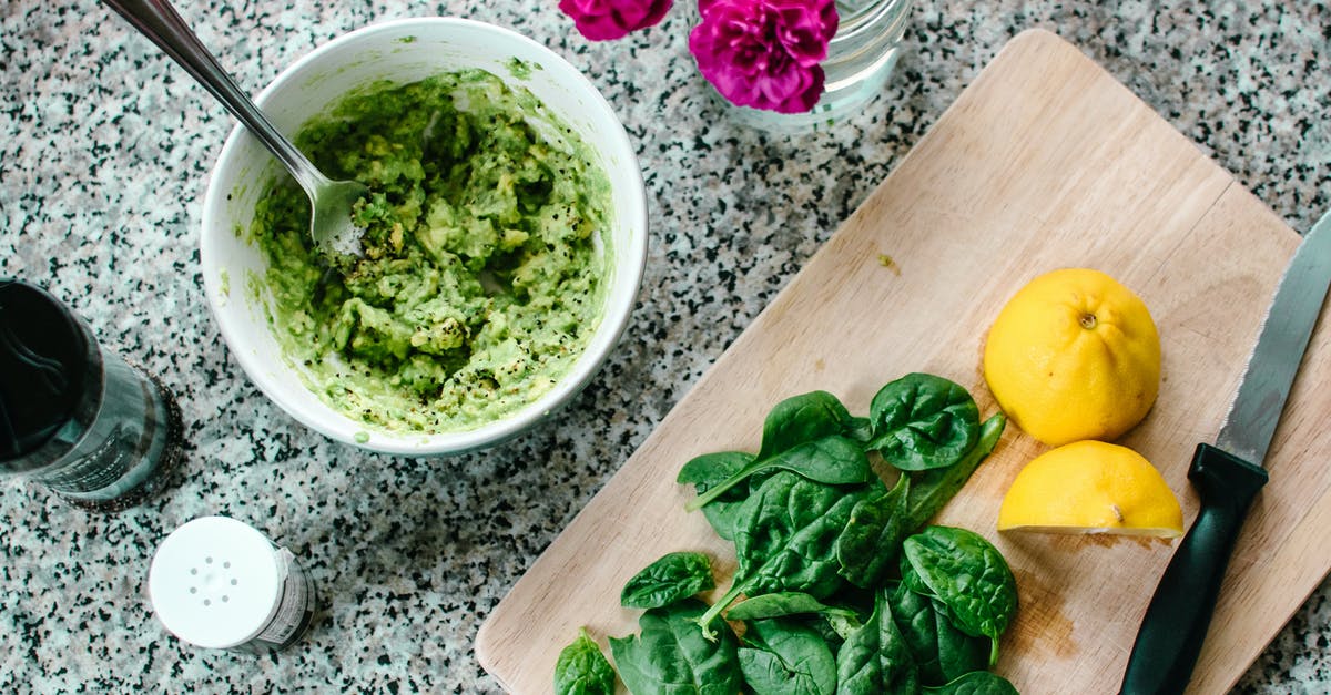 Nutrient impact of squeezing water out of frozen chopped spinach - Sliced Lemon Beside Vegetable on Brown Wooden Chopping Board