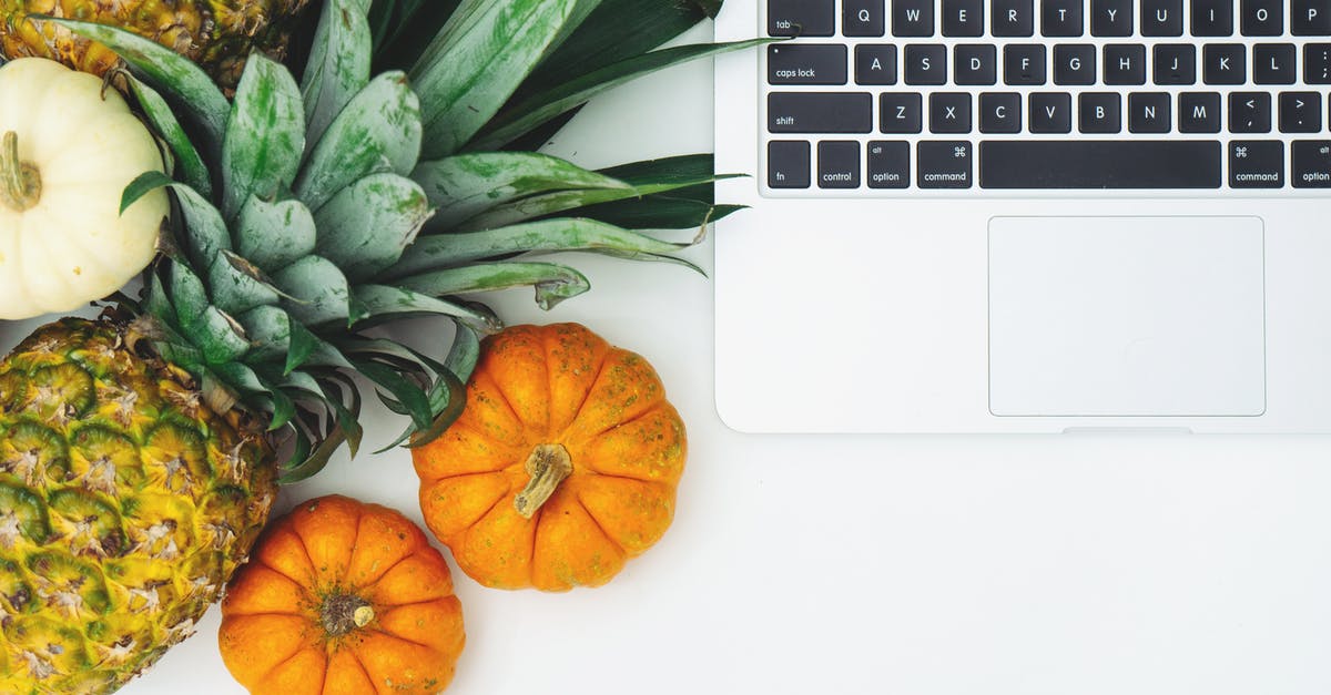 Nutritional information on fruits and veggies - Pumpkins and Pineapple Next to Laptop