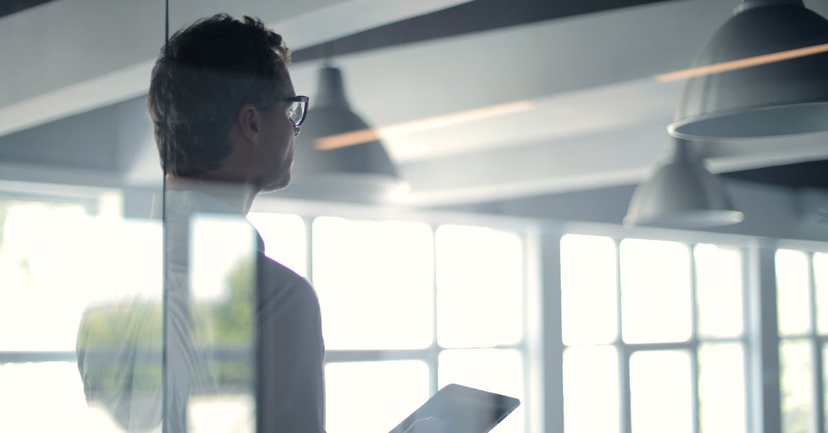 Office (Loose Leaf) Tea Solution - Formal man with tablet giving presentation in office