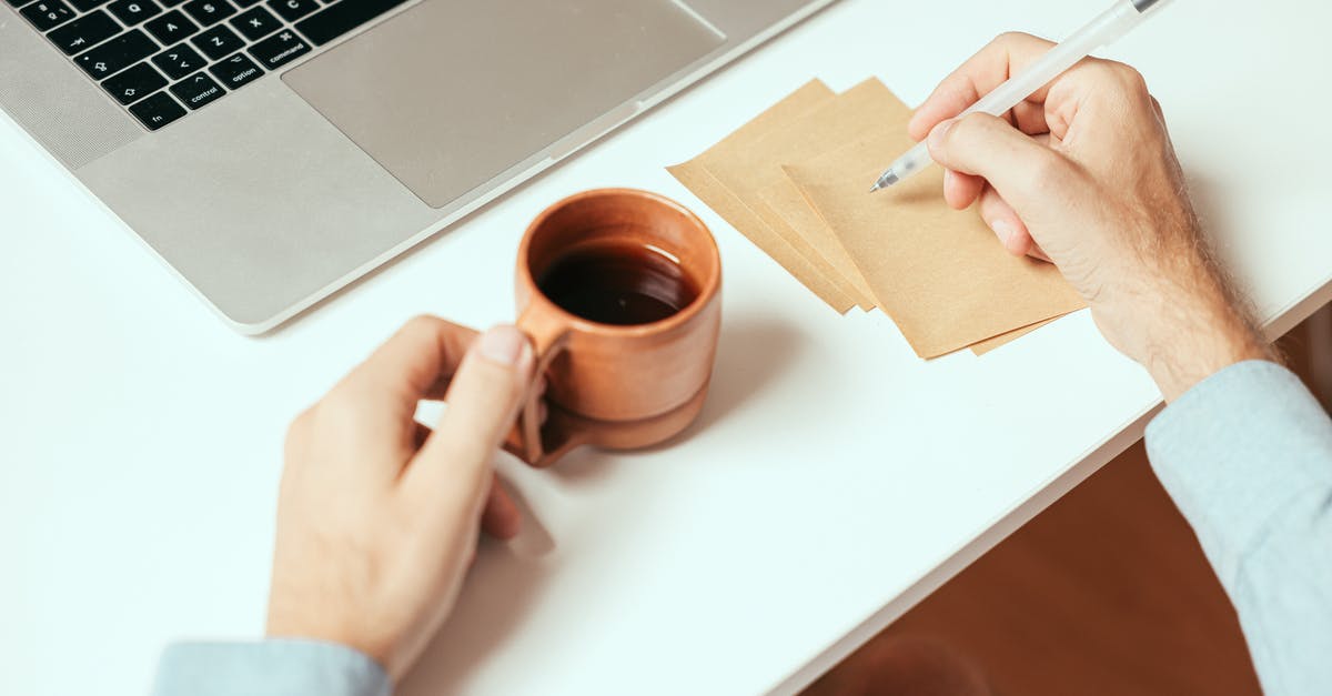 oil for tabletop working dough - A Person Holding a Cup of Coffee while Taking Notes