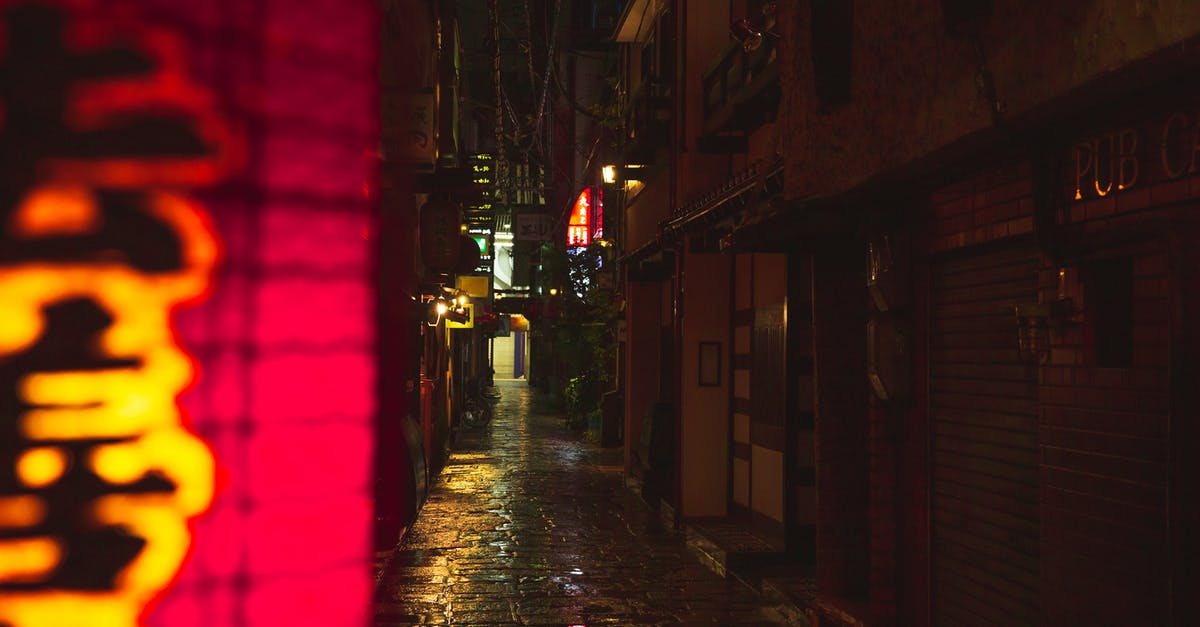 old electric Farberware wok - Narrow street with wet cobblestone footpath