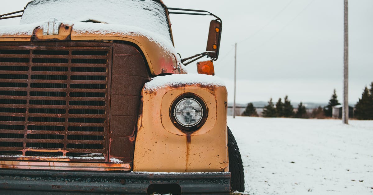 Old frozen ground lamb - safe to eat? [duplicate] - Yellow old timer truck with headlight covered with frost parked on snowy terrain against trees in rural terrain on winter day