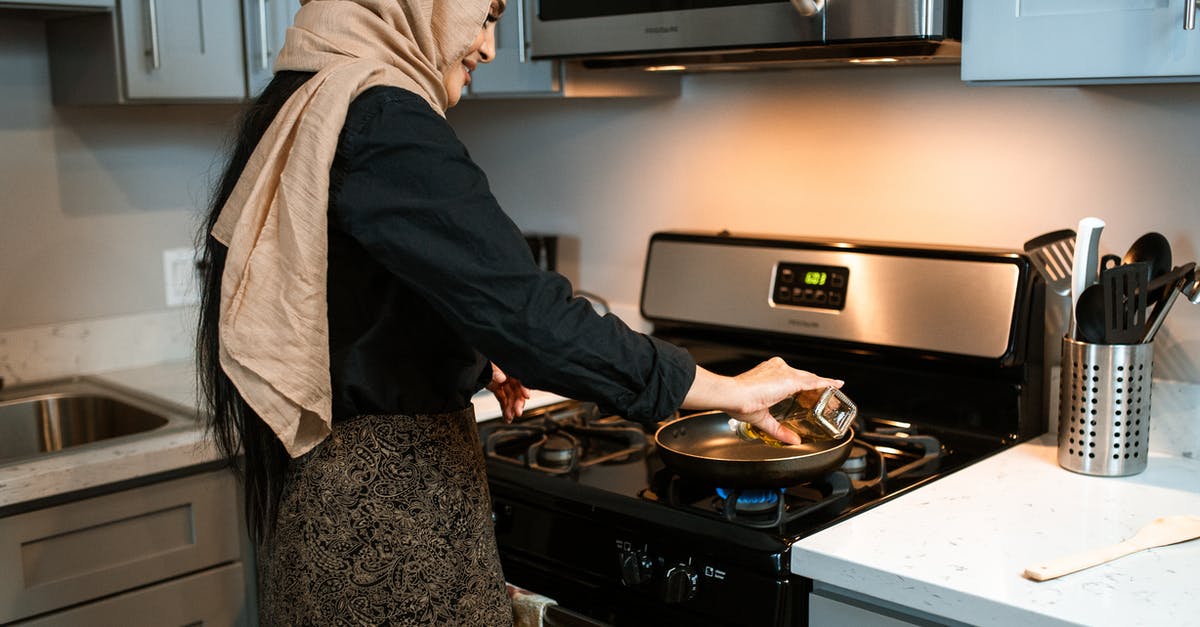 Olive oil instead of peanut oil to air fry potato? - Crop ethnic woman pouring oil on pan