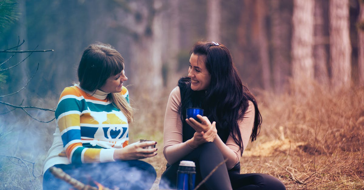 Olive oil "shelf" life and summer camping - Two Women Sitting on Ground Near Bonfire