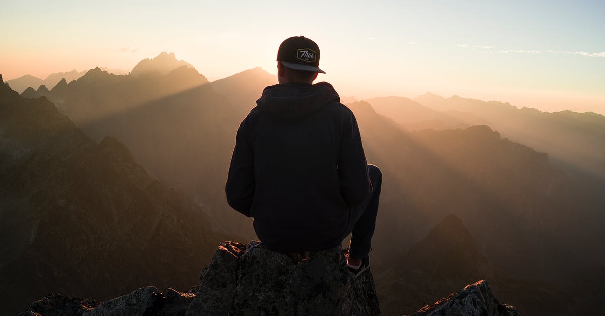 Olive oil "shelf" life and summer camping - Man Sitting on the Mountain Edge