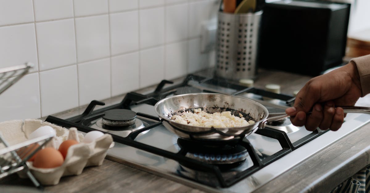 Omelette cooked in oven or pan? - Person Holding Stainless Steel Cooking Pan