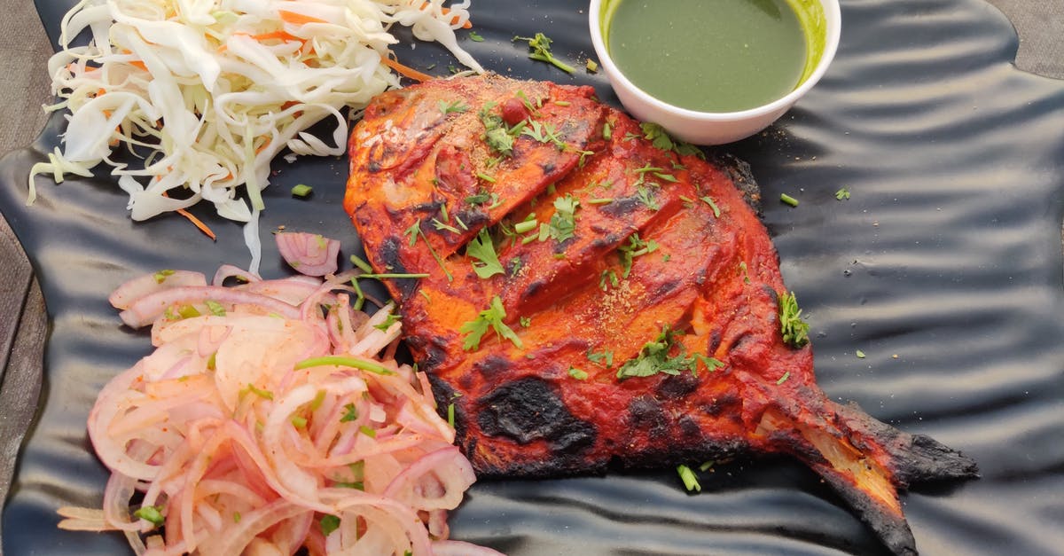 Oniony coleslaw - Cooked Meat With Green Vegetable on Black Round Plate