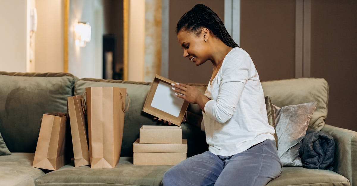 Opening potato bags - Woman Sitting on Couch Opening Brown Boxes and Paper Bags